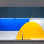 Suprematist abstract painting inspired by Kazimir Malevich depicting a kitchen countertop brightly illuminated by an LED light strip mounted beneath floating upper cabinets. Minimalist composition of bold navy blue and vibrant yellow geometric shapes on a stark white background. Flat textures, sharp edges, avant-garde electrical concept, no humans, no text.