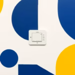 Suprematist abstract painting in the style of Kazimir Malevich featuring a smart connected home control hub emitting wireless signals. Minimalist composition of bold navy blue and vibrant yellow geometric shapes on a stark white background. Flat textures, sharp edges, avant-garde smart home electrical concept. No humans, no text overlay.