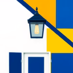 Suprematist abstract painting inspired by Kazimir Malevich, featuring a modern outdoor LED wall lantern mounted above a front entrance door. Minimalist composition of bold navy blue and vibrant yellow geometric shapes on a stark white background, flat textures, sharp edges, avant-garde electrical concept art. No humans, no text overlay.