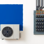 Suprematist abstract painting featuring a heat pump outdoor unit connected to an electrical distribution panel with circuit breakers. Minimalist composition of bold navy blue and vibrant yellow geometric shapes on a stark white background. Flat textures, sharp edges, avant-garde electrical concept. No humans, no text, no lettering.