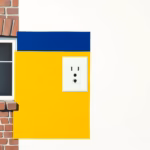 Suprematist abstract painting in the style of Kazimir Malevich featuring a two-prong wall outlet mounted beside the facade of an old red brick French farmhouse. Minimalist composition of bold navy blue and vibrant yellow geometric shapes on a stark white background. Flat textures, sharp edges, avant-garde electrical concept, clean geometric balance. No humans, no text.