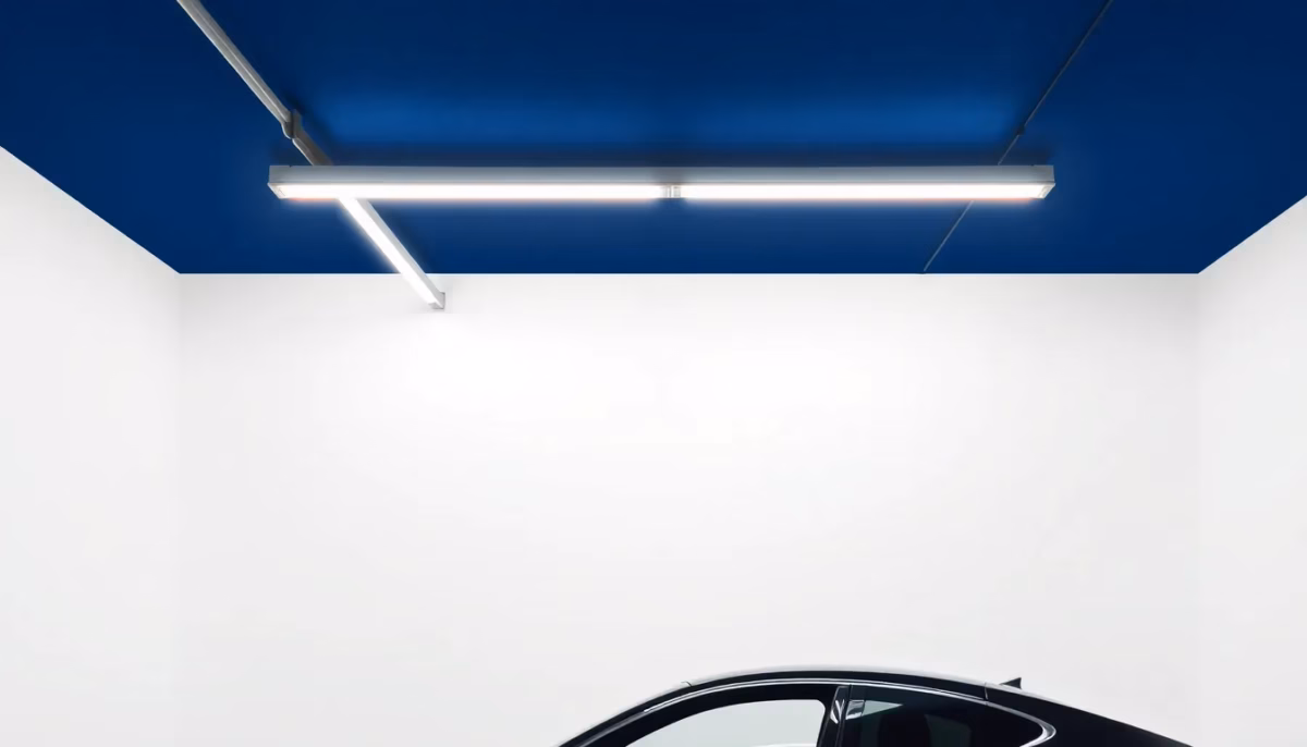 Suprematist abstract painting in the style of Kazimir Malevich depicting a garage ceiling fitted with linear LED batten lights glowing brightly above a car silhouette. Minimalist composition of bold navy blue and vibrant yellow geometric shapes on a stark white background. Flat textures, sharp edges, avant-garde electrical concept, no humans, no text overlay.