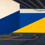 Suprematist abstract painting by Kazimir Malevich featuring old fabric-insulated electrical cables running across the dusty floor of a dark attic. Minimalist composition of bold navy blue and vibrant yellow geometric shapes on a stark white background. Flat textures, sharp edges, avant-garde electrical concept. No humans, no text, no lettering, no overlay.