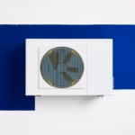 Suprematist abstract painting by Kazimir Malevich featuring a reversible air-to-air heat pump split unit transferring warm and cool air flows. Minimalist composition of bold navy blue and vibrant yellow geometric shapes on a stark white background. Flat textures, sharp edges, avant-garde electrical concept. No humans, no text.