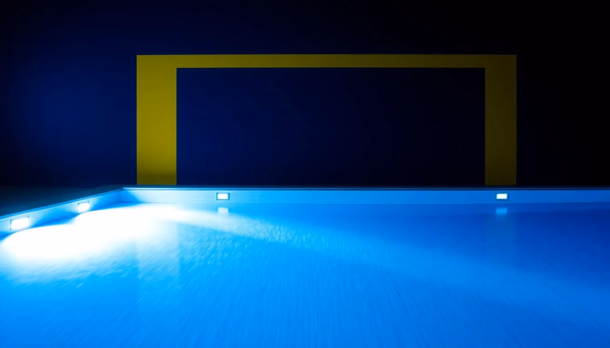 Suprematist abstract painting by Kazimir Malevich featuring an illuminated swimming pool at night with submerged LED projectors casting geometric beams of light through the water. Minimalist composition of bold navy blue and vibrant yellow geometric shapes on a stark white background. Flat textures, sharp edges, avant-garde electrical concept. No humans, no text, no words, no letters, no logos, no watermark, no text overlay.