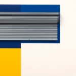 Suprematist abstract painting in the style of Kazimir Malevich featuring a remote-controlled roller shutter and concentric radio waves. Minimalist composition of bold navy blue and vibrant yellow geometric shapes on a stark white background. Flat textures, sharp edges, avant-garde electrical concept. No humans, no text, no letters, no watermark, no overlay.
